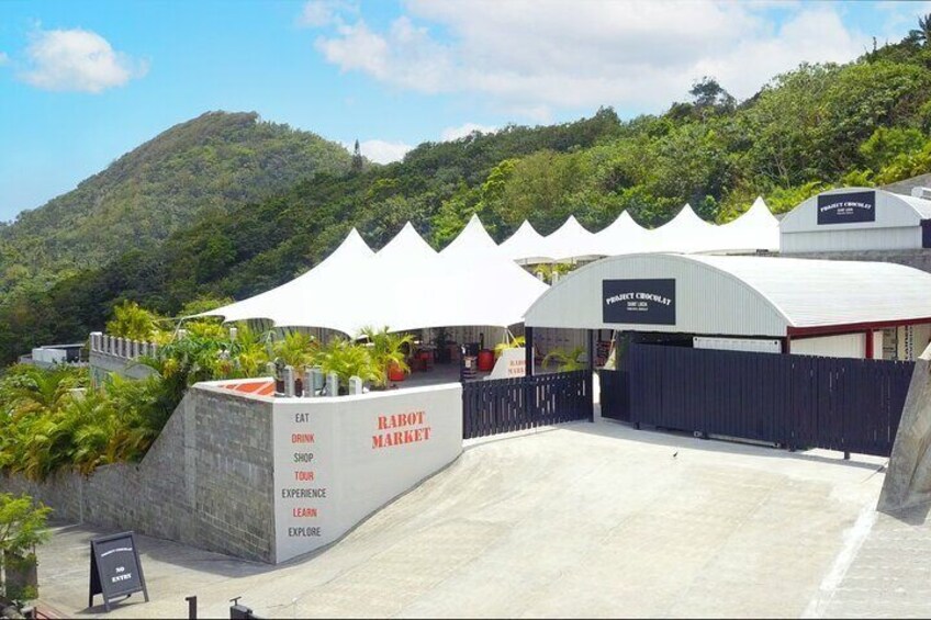 A market with white tents and a sign that reads "RABOT MARKET". 3