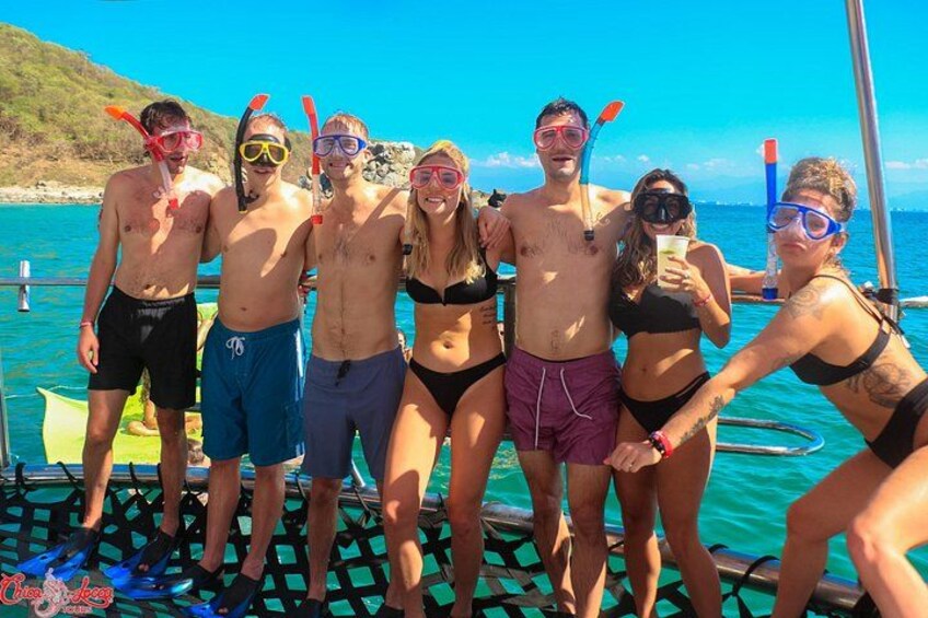 A group of people on a boat with water and a clear sky in the background. 2