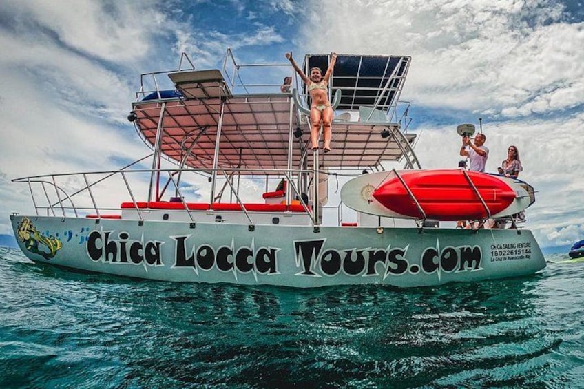 A boat named 'Chica Locca Tours.com' with a person standing on the deck. 1