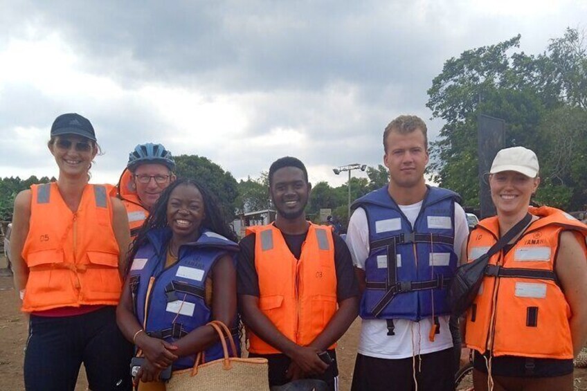 A group of people wearing life jackets and helmets, standing outdoors. 5