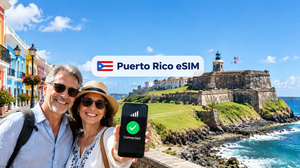 A couple holding a smartphone with a connected eSIM icon, with a view of a coastal cityscape including a fort and buildings. 1