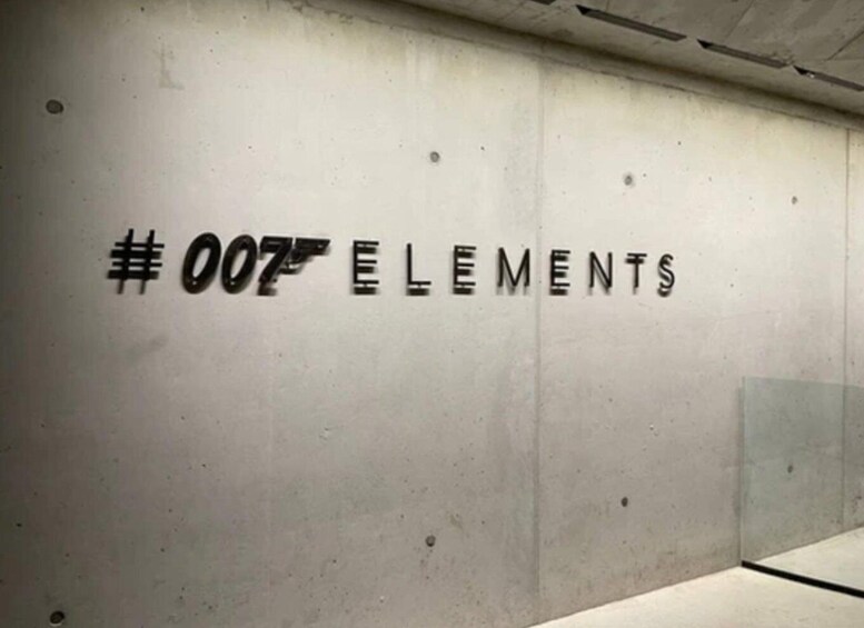 A wall with the text "#007 ELEMENTS" in a bold, black font. 2