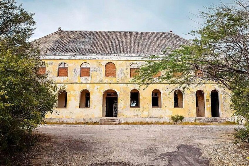 The Quarantine Building is a historic building with a distinctive yellow facade and red roof tiles, located on the coast of Curacao. Once used for medical quarantine, it now exudes colonial charm 2