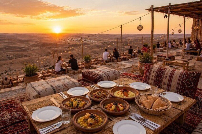 A table set for a meal with dishes and a sunset view. 1