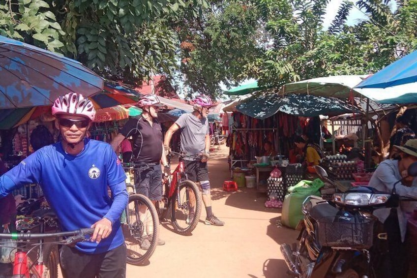 A market with bicycles and people. 4
