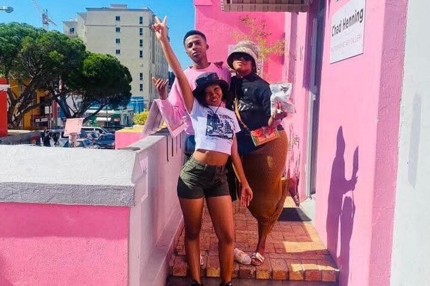 A pink building with a sign reading 'Chef Henning.' 4