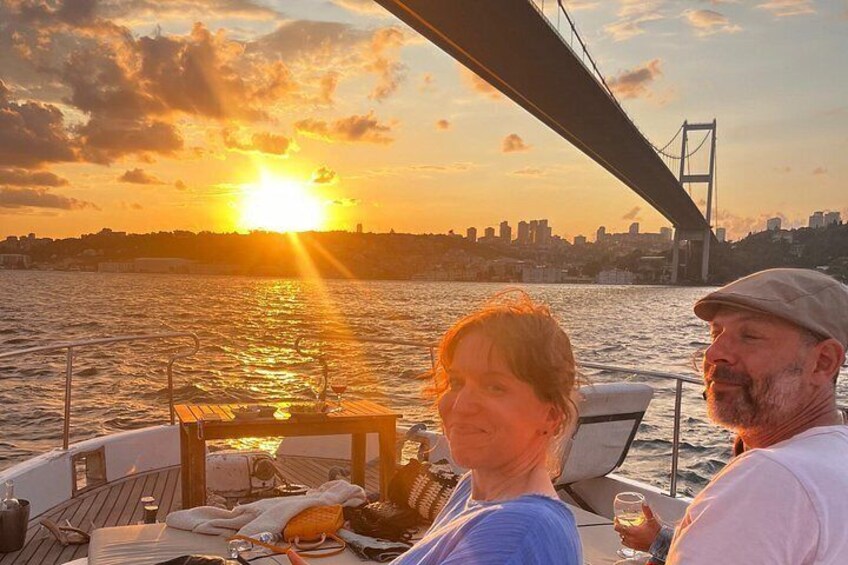 A sunset over a body of water with a bridge in the background. 4