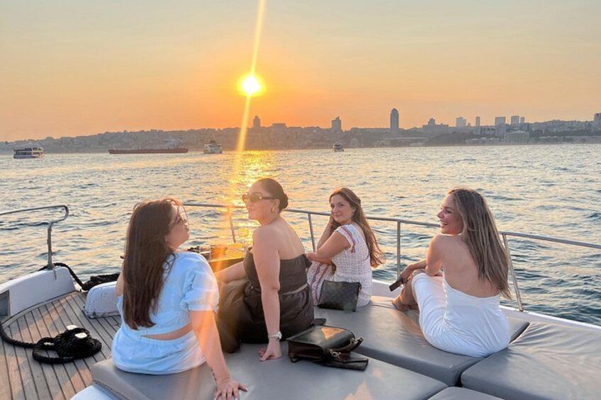 A sunset over a body of water with a city skyline in the background. 3