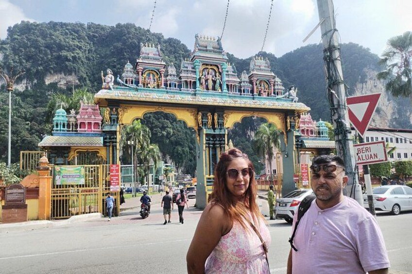 A colorful temple entrance with a sign reading 'BERI ALUAN' and a mountainous backdrop. 2
