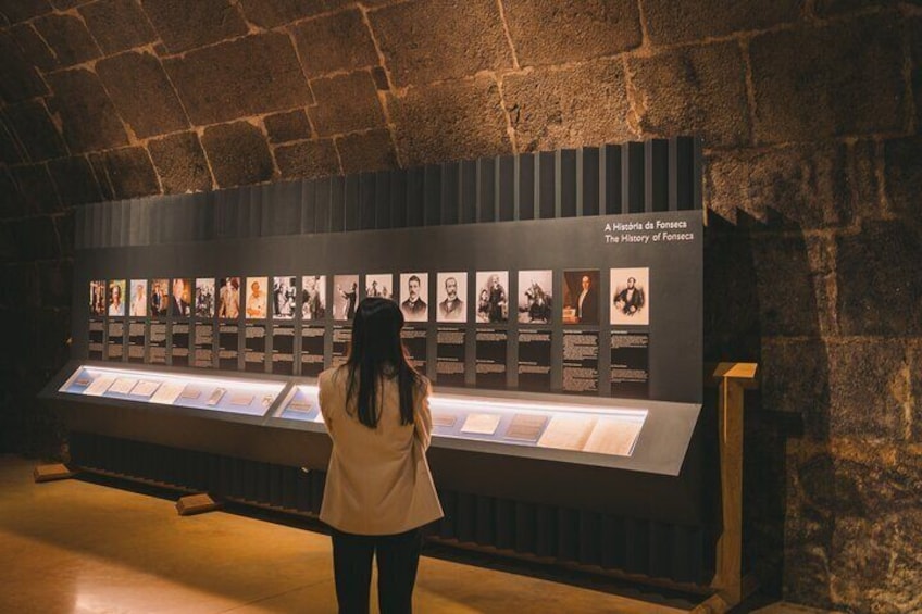 A person viewing a display of historical photographs in a museum. 3