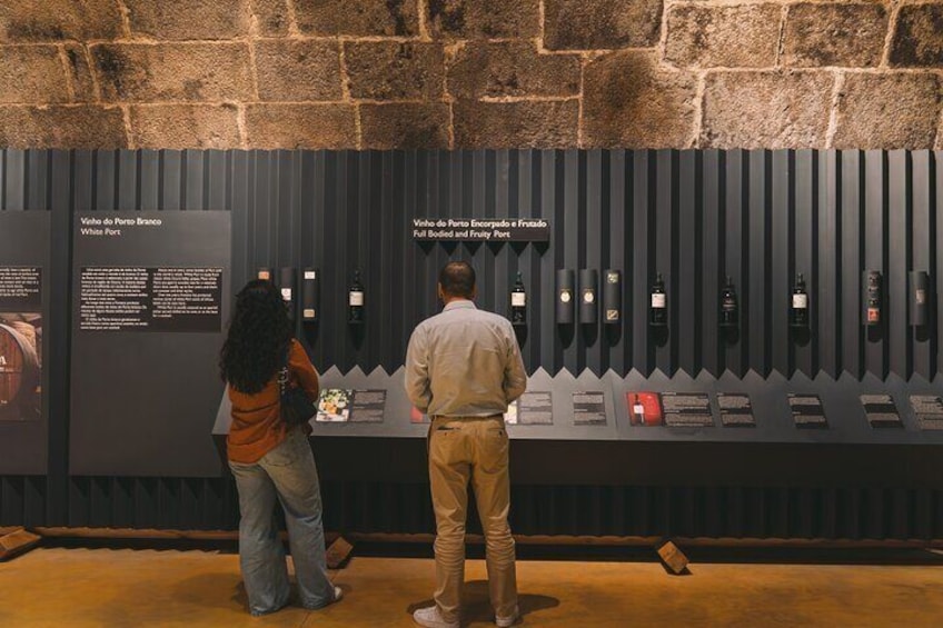 Two people examining a wine display at a museum. 5