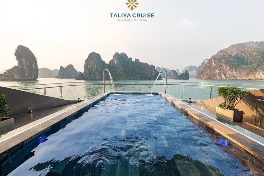 A pool with a view of limestone karsts and water. 4
