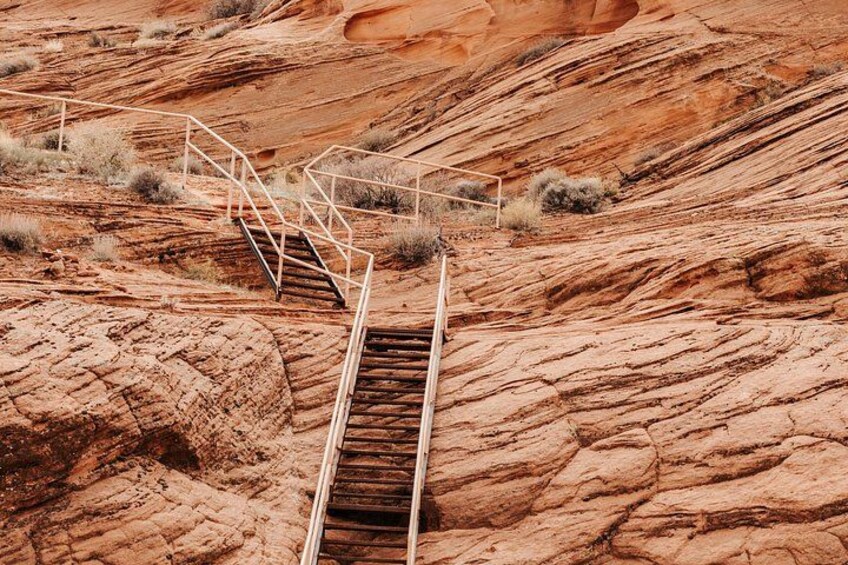 A metal staircase leading up a rocky hillside. 2