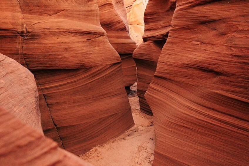 A canyon with smooth, reddish rock formations. 5
