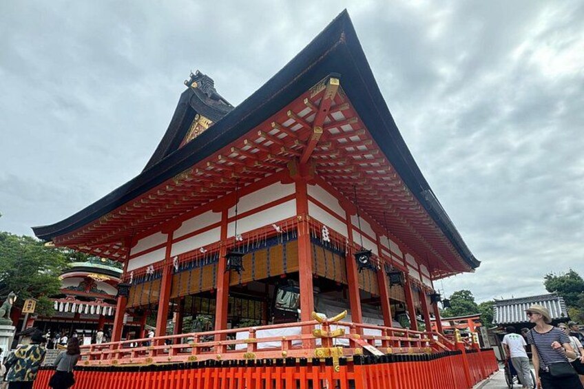 A traditional Japanese building with a red roof and black and white walls. 5