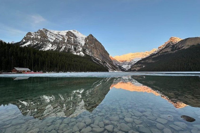 A mountain range, a lake, and a cabin. 4