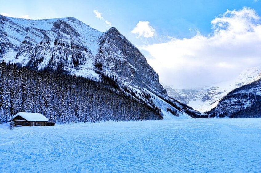 A snow-covered mountain landscape with a cabin and a clear sky. 3