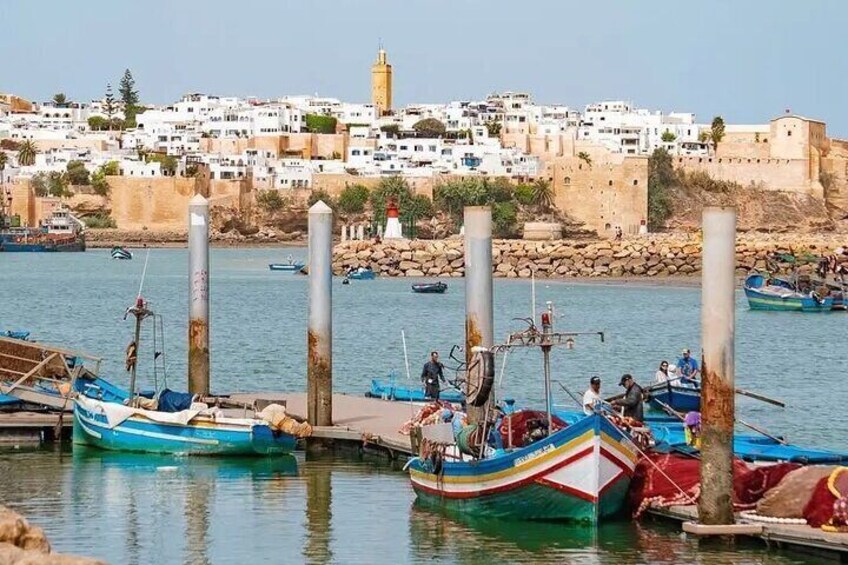 A harbor with boats docked, a cityscape in the background, and a prominent lighthouse. 3