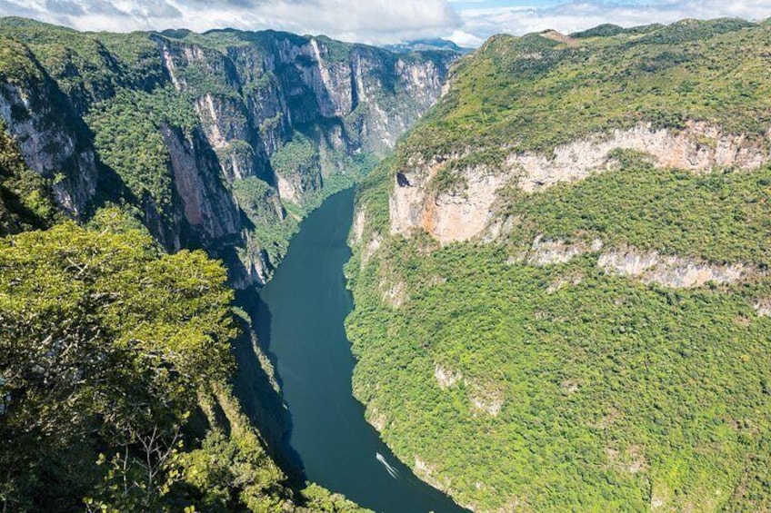 A deep canyon with steep cliffs and a river running through it. 2