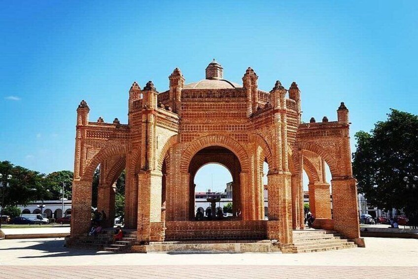 A large brick archway with multiple arches and a dome structure. 3