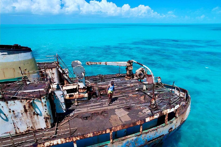 A rusted shipwreck in clear turquoise waters. 4