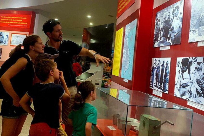 A museum exhibit with informational posters and a glass display case. 5