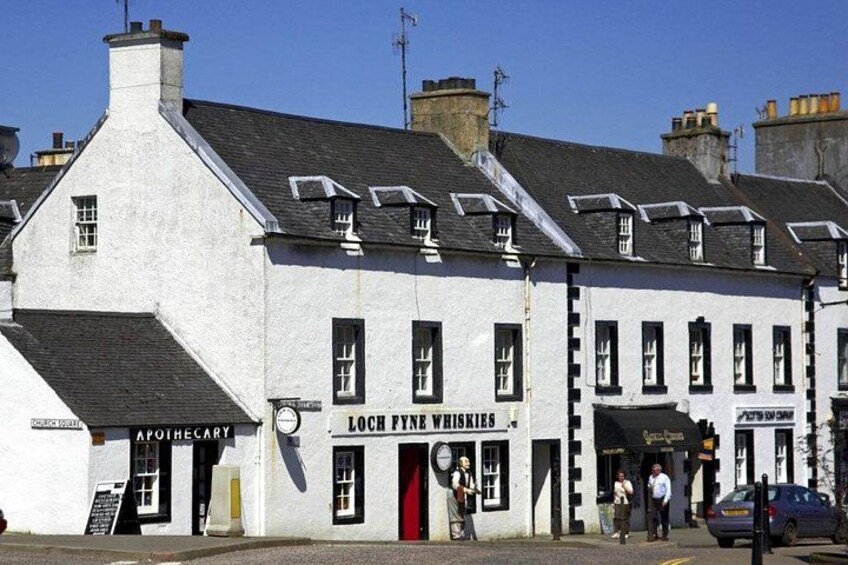 A white building with a sign for Loch Fyne Whiskies. 3
