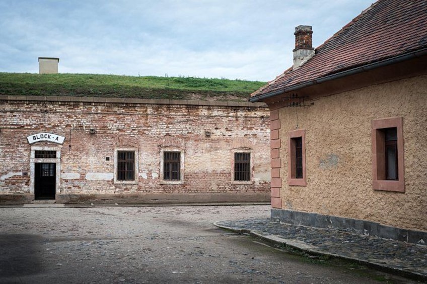 A historic building labeled 'BLOCK-A' with a brick facade and a red-tiled roof. 4