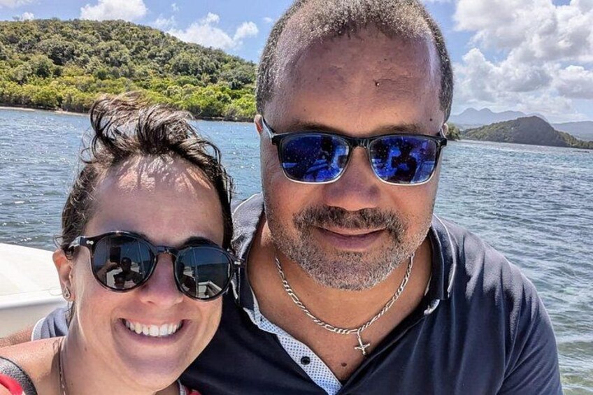 Twee personen in een boot, met een meer en bergen op de achtergrond. 4