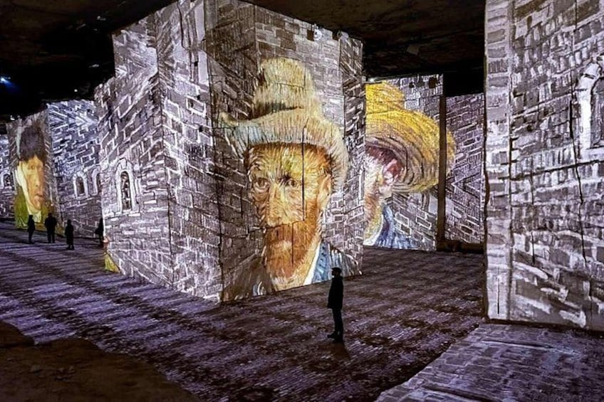 A large-scale light projection of a mural on brick walls in an indoor setting. 4