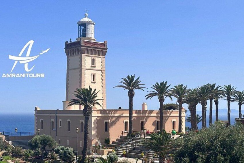 A coastal building with a lighthouse, palm trees, and a clear blue sky. 3