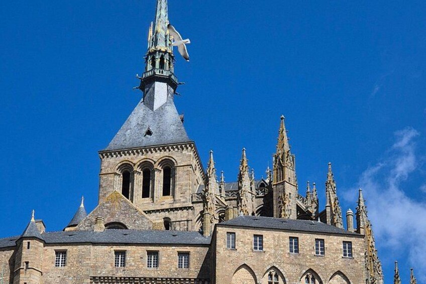 A historic building with a pointed tower and intricate architectural details. 5