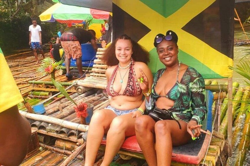 Two people sitting on a wooden bench with a colorful backdrop. 2