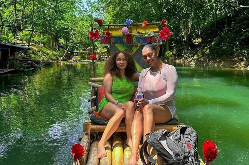 Two people sitting on a boat in a river surrounded by greenery. 2