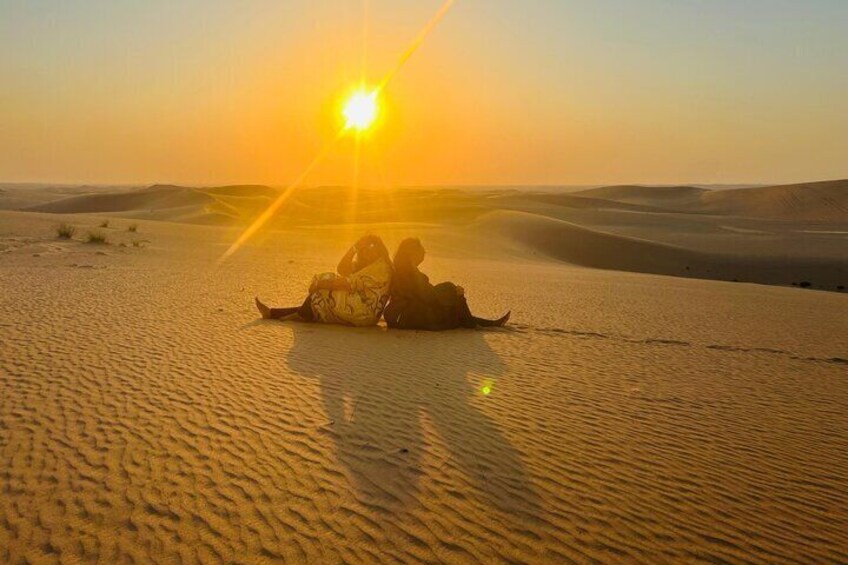 A desert landscape with sand dunes and a sunset. 1