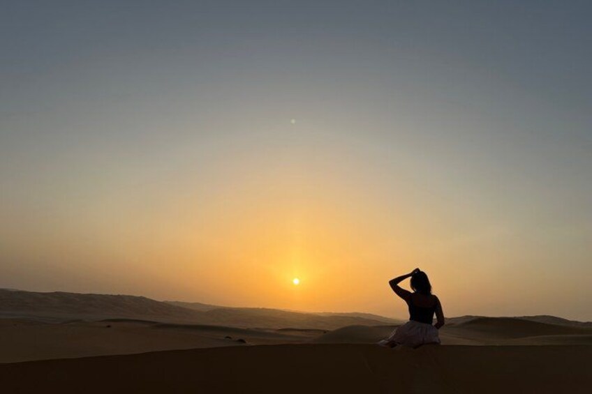 A person in a desert landscape at sunset. 3