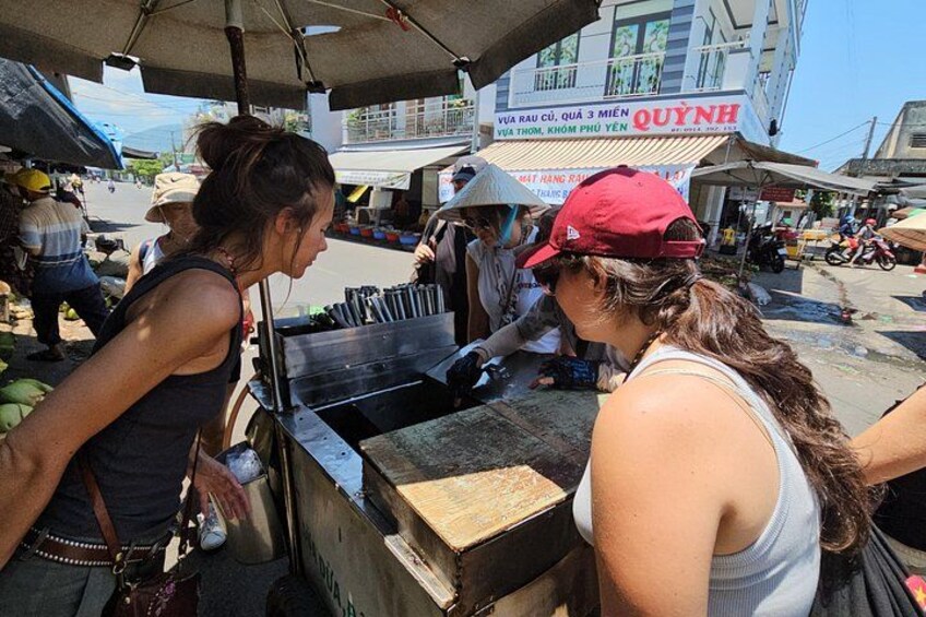 Street food vendors preparing food at a market. 5
