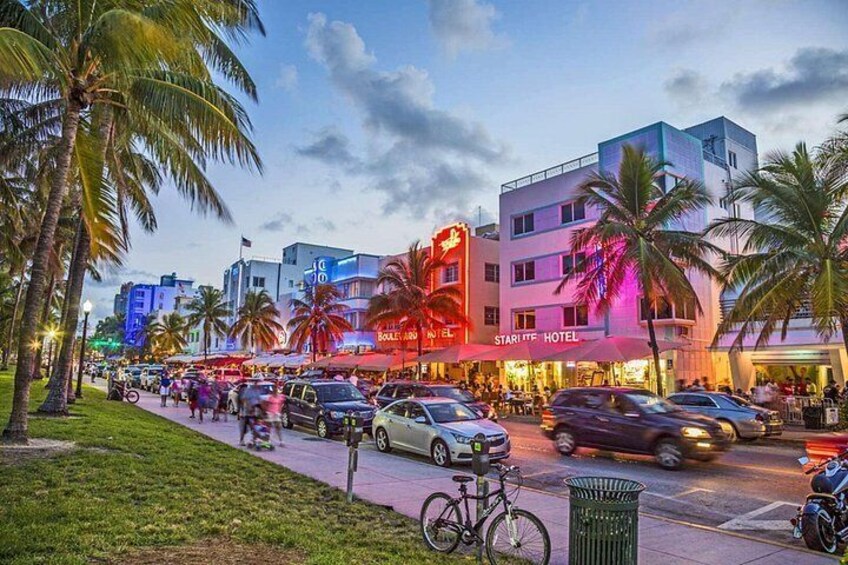 A busy street with palm trees, cars, and a hotel named 'Starff Hotel'. 5