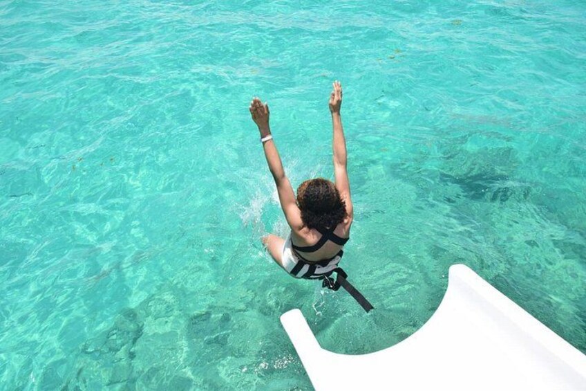 A person snorkeling in clear turquoise water. 4