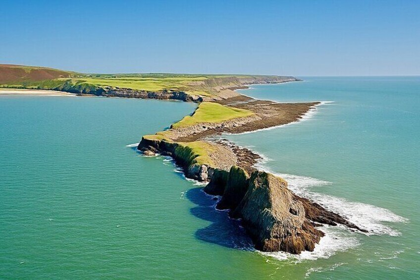 A coastal landscape with cliffs and a clear blue sea. 5