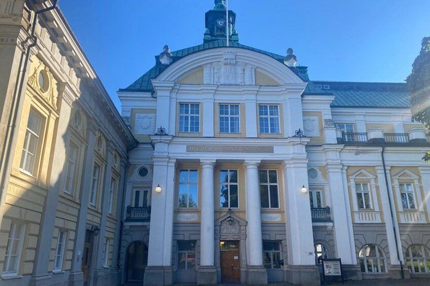 A classical building with a central dome, columns, and a clock. 2