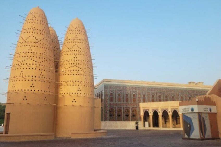 A large building with two tall, pointed structures in front. 4