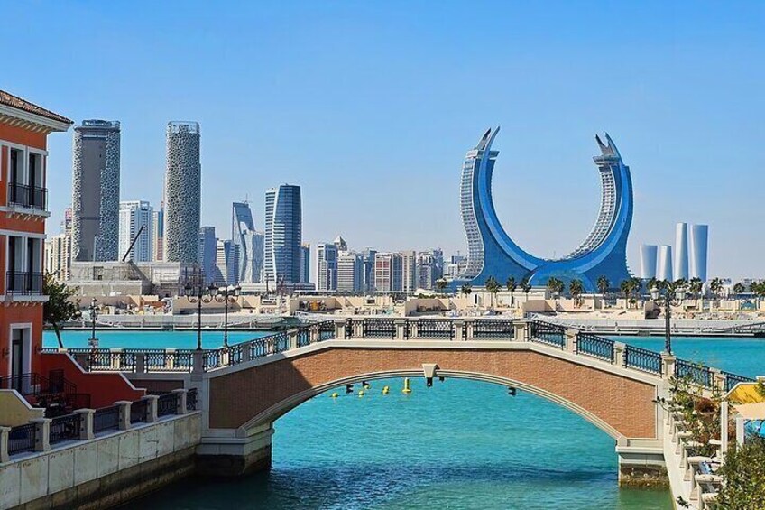 A bridge over water with a city skyline in the background. 3