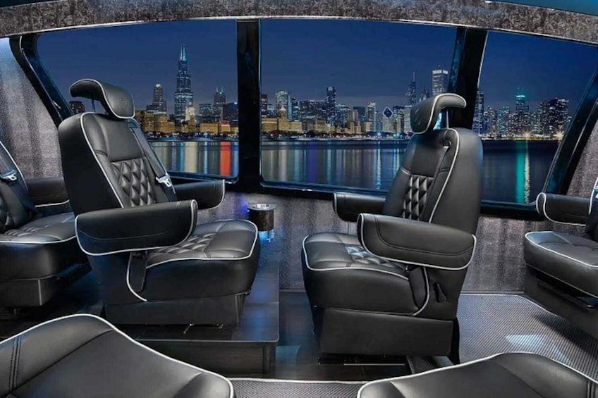 A luxurious car interior with black leather seats and a panoramic cityscape view. 4