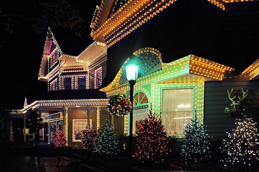 A house with colorful lights and Christmas decorations. 1