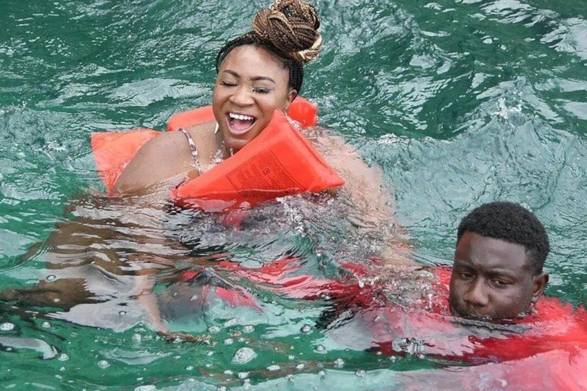 Two people in water with life jackets. 1