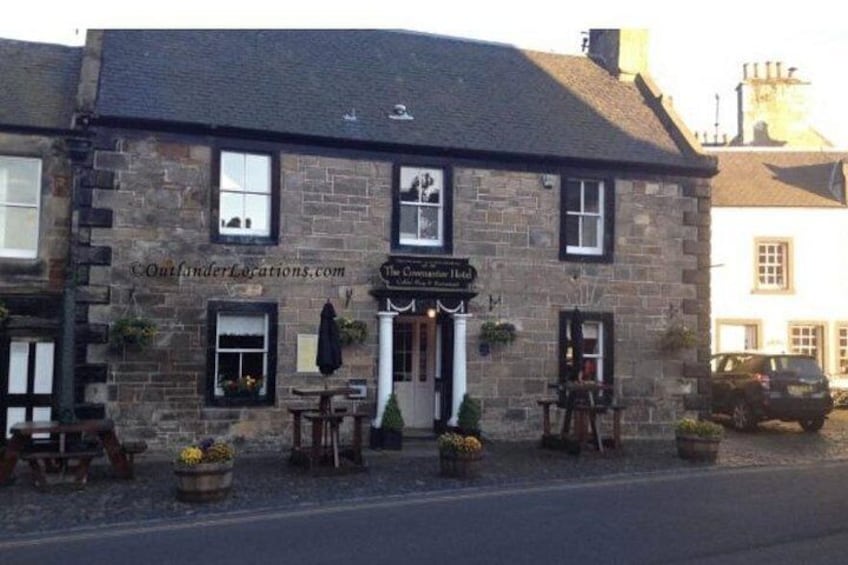 A stone building with a sign reading 'The Corner House.' 2