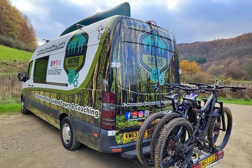 A mountain bike touring van with a rear rack and a mountain bike mounted on it. 2