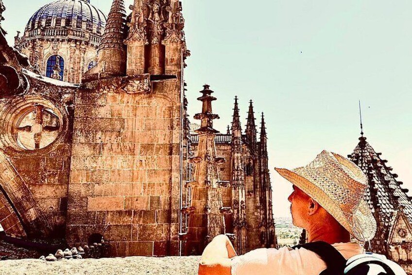 A historic cathedral with intricate architecture, a person wearing a straw hat, and a circular window. 3
