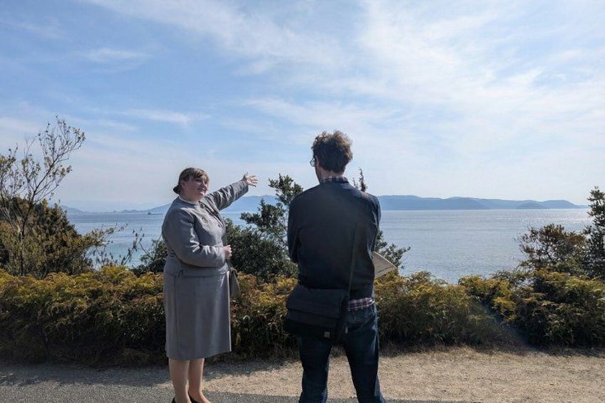 Two people standing by a body of water with a clear sky. 3